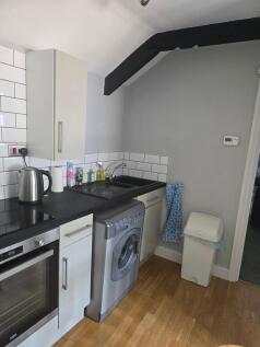 A modern kitchen featuring a built-in oven with...