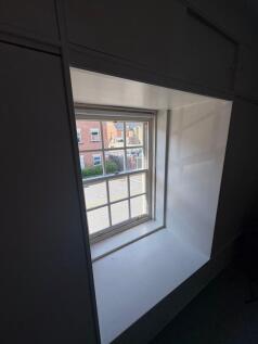 A bright window with multiple small panes overl...