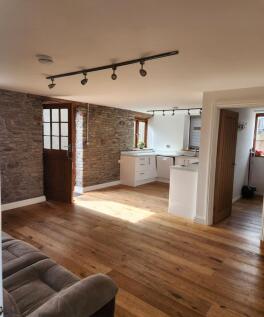 A charming living room with rustic exposed ston...