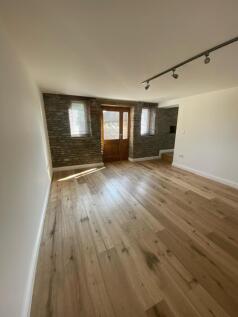 A charming living room featuring beautiful natu...