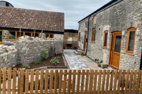 A charming, well-maintained garden area featuri...