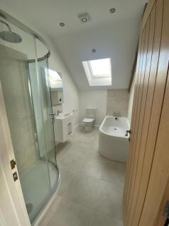 Bright and modern bathroom suite featuring a sp...
