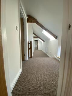 Bright and spacious hallway featuring skylights...