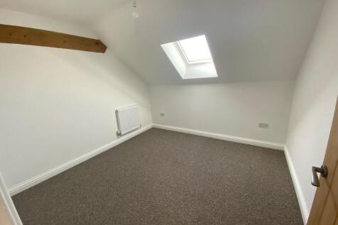 A clean and bright single bedroom featuring a s...