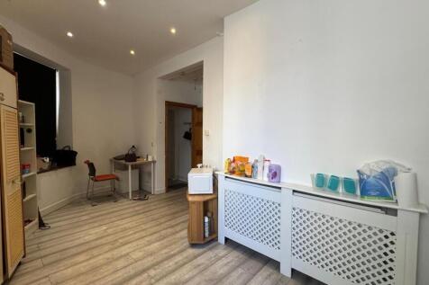 Bright kitchen space featuring modern wood-effe...