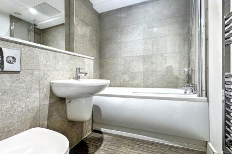 Bright and modern bathroom featuring a clean wh...