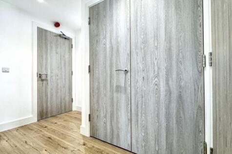 Bright and clean hallway featuring modern woode...