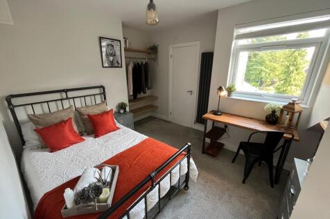 A bright and inviting double bedroom featuring ...