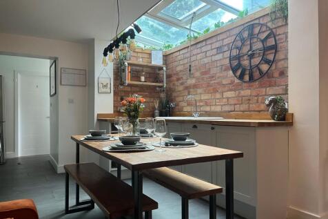 A stylish kitchen area featuring a rustic woode...