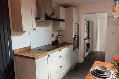 A modern kitchen featuring wooden countertops, ...