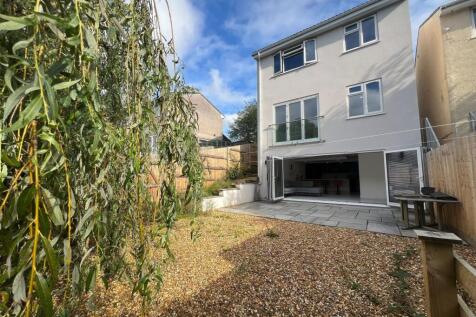 A bright and spacious garden area featuring a w...