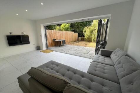 A modern living room featuring a plush grey sec...