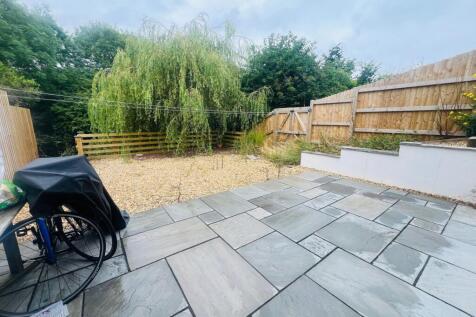 A spacious and well-maintained garden area feat...