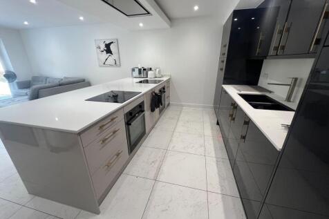 Modern kitchen with sleek black and white cabin...