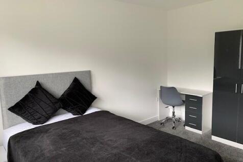 A modern double bedroom featuring a comfortable...