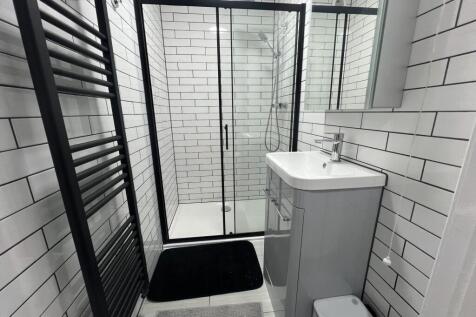 Modern bathroom featuring sleek white subway ti...
