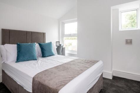 A bright and modern double bedroom featuring a ...