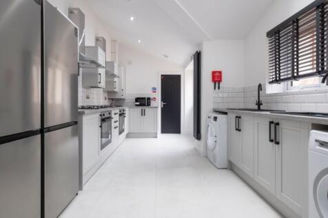 A modern and spacious kitchen with sleek applia...