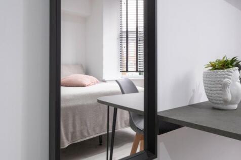 A stylish and inviting double bedroom with ampl...