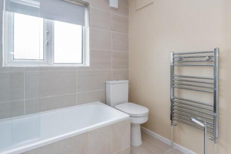 Bright and modern bathroom featuring a clean ba...