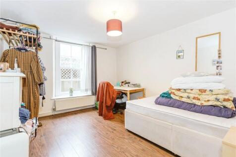 Bright and spacious bedroom featuring a large w...