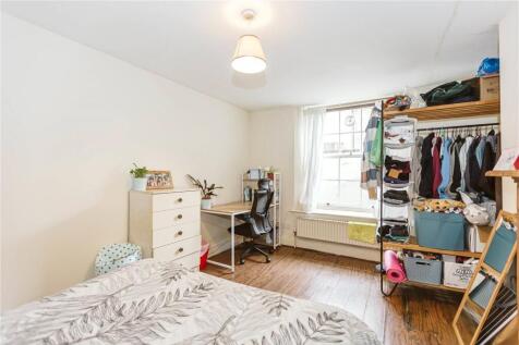 Bright and neatly arranged double bedroom with ...
