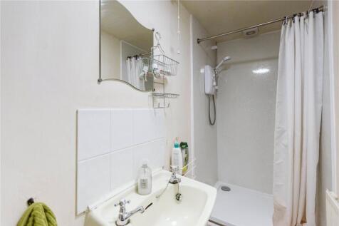 A clean and functional bathroom featuring a sho...