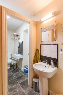 Compact bathroom featuring a modern sink with s...