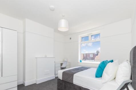 This inviting double bedroom features a comfort...