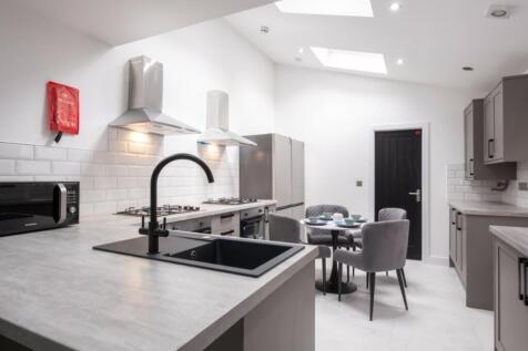 Bright and modern kitchen featuring sleek count...