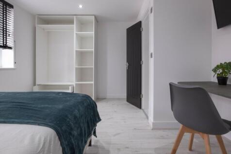 A bright and spacious double bedroom featuring ...