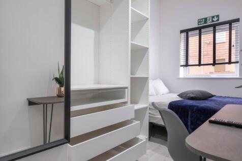 A modern and well-lit double bedroom featuring ...