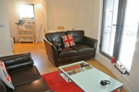 A cozy, well-lit living room featuring comforta...