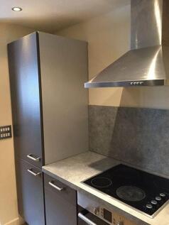Modern kitchen with sleek grey cabinets and a s...