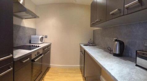 A modern kitchen featuring sleek cabinetry, a b...