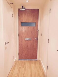 A clean, well-maintained hallway featuring ligh...