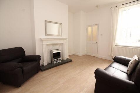 A bright and inviting living room featuring com...