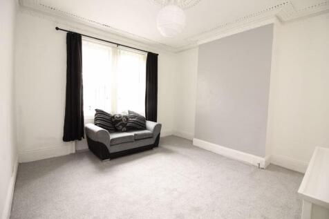 A bright double bedroom featuring a large windo...