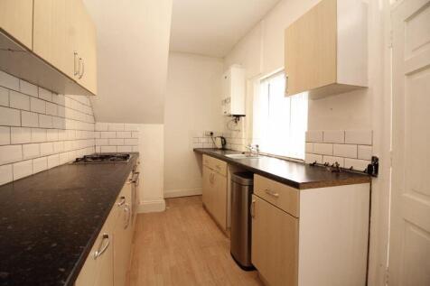 A bright and tidy kitchen featuring modern cabi...