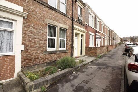 A charming terraced brick house with well-maint...