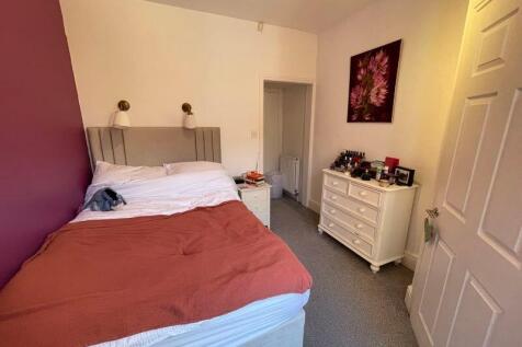 A cozy and well-kept double bedroom featuring a...