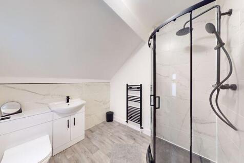 A modern and spacious bathroom suite featuring ...