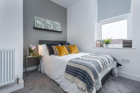 A bright and cozy double bedroom featuring a co...