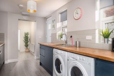 Bright and modern kitchen featuring spacious wo...