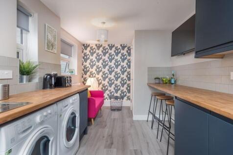 Bright and modern kitchen featuring sleek woode...
