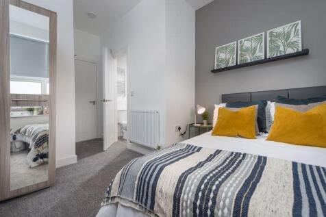 A bright and cozy double bedroom featuring a co...