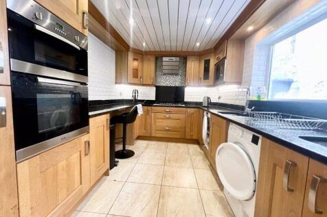 Bright and welcoming kitchen with ample natural...