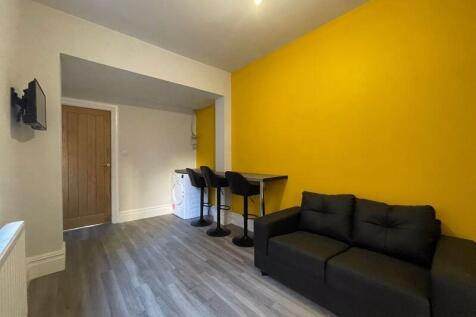 A modern living room featuring a vibrant yellow...