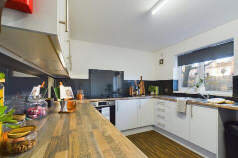 A modern and spacious kitchen with ample natura...