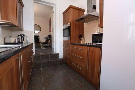 A well-maintained kitchen with wooden cabinetry...